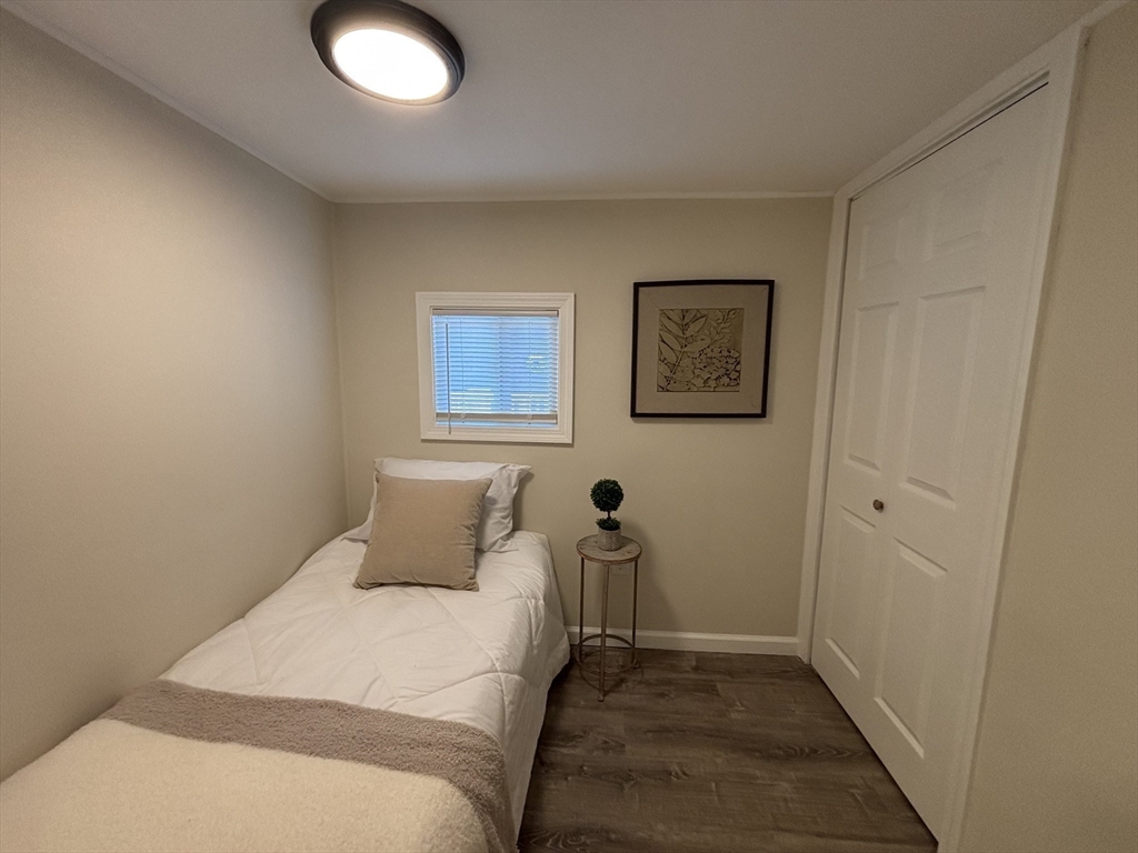 229 Miller Street, Unit D6 Ludlow, MA 01056 - Photo 15 of 24 a bedroom with a bed and painting on the wall