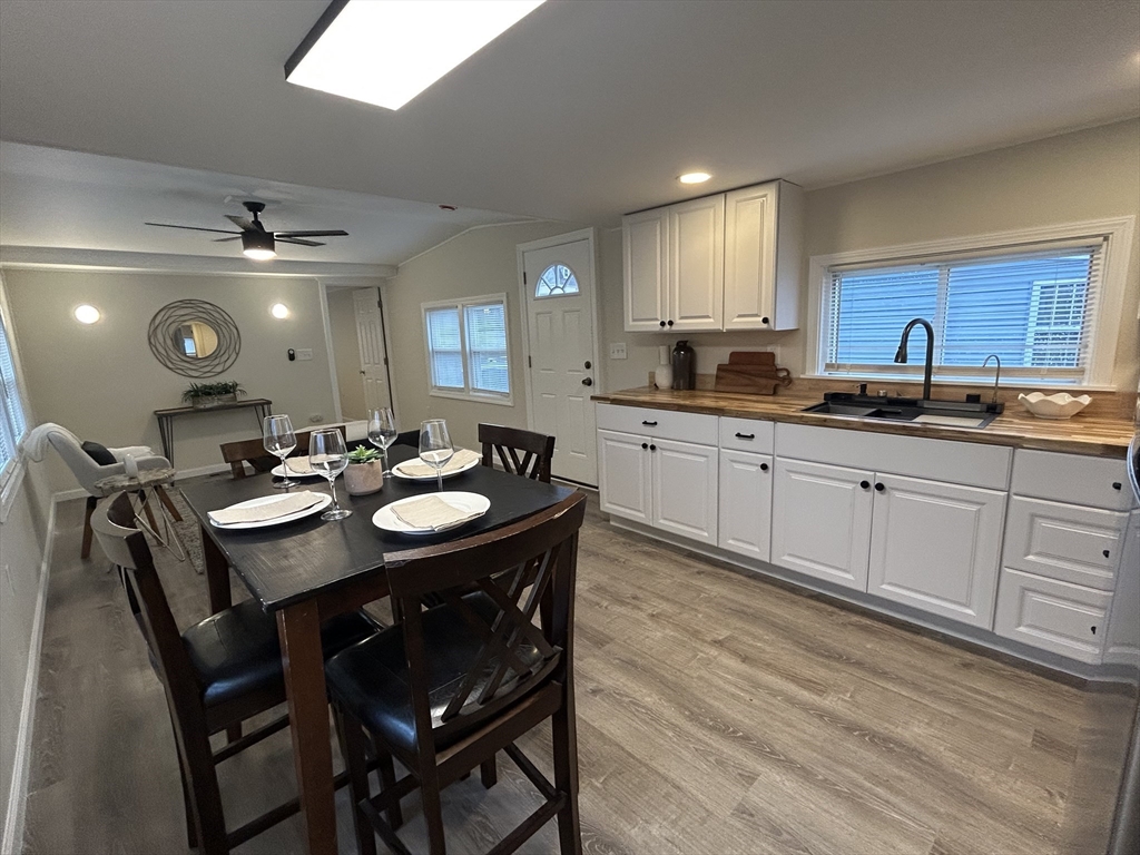 229 Miller Street, Unit D6 Ludlow, MA 01056 - Photo 2 of 24 a kitchen with sink dining table and chairs
