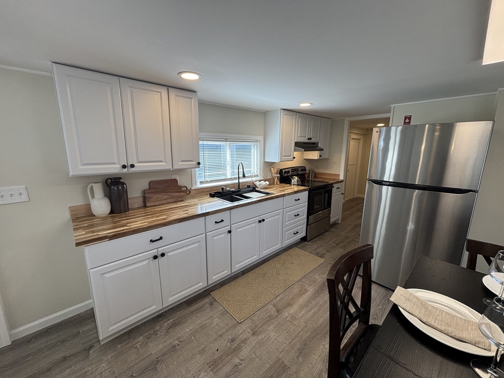229 Miller Street, Unit D6 Ludlow, MA 01056 - Photo 5 of 24 a kitchen with stainless steel appliances a refrigerator sink and cabinets