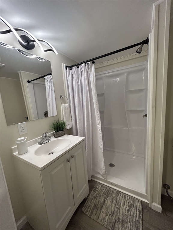 229 Miller Street, Unit D6 Ludlow, MA 01056 - Photo 10 of 24 a bathroom with a sink and a mirror