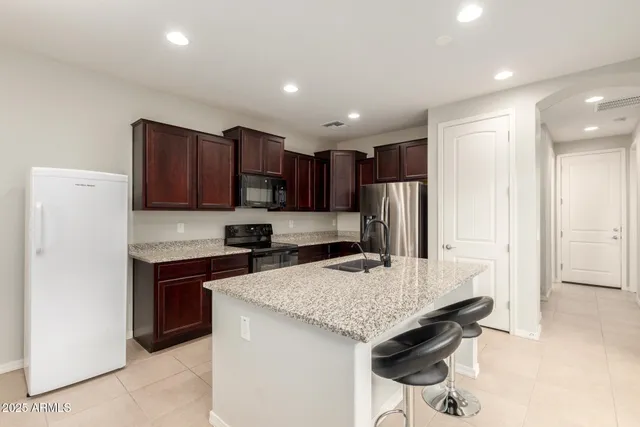 a kitchen with a sink stove and refrigerator
