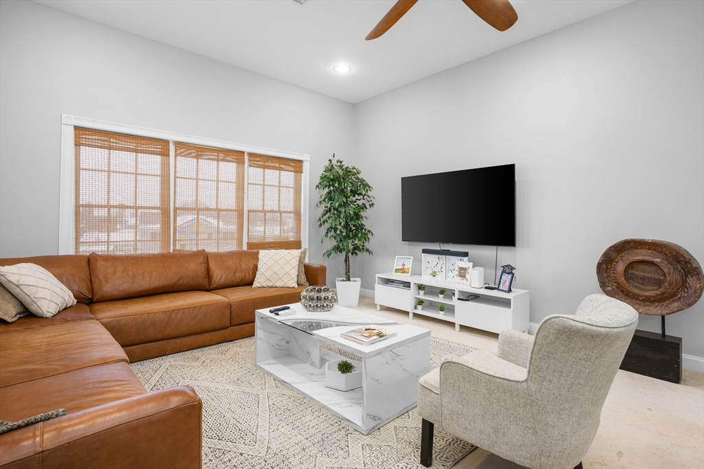 68 Center Street, Unit 13 Barnstable, MA 02601 - Photo 1 of 29 a living room with furniture and a flat screen tv