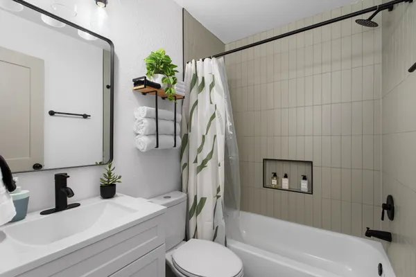 a bathroom with a sink a toilet and a bathtub