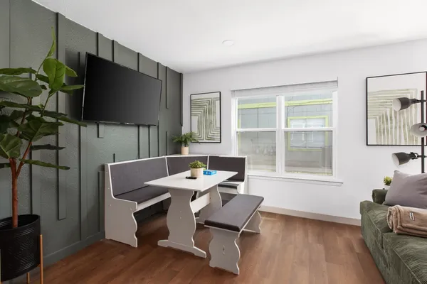 a dining room with furniture and window