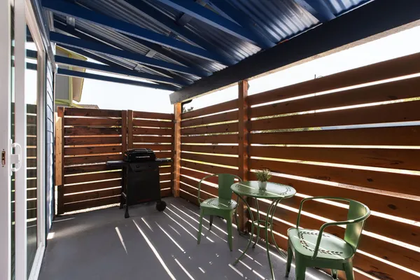 a view of outdoor space with wooden floor and windows