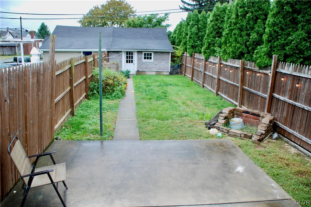 30 North 5th Street Emmaus, PA 18049 - Photo 18 of 20 a view of a backyard with table and chairs and wooden fence