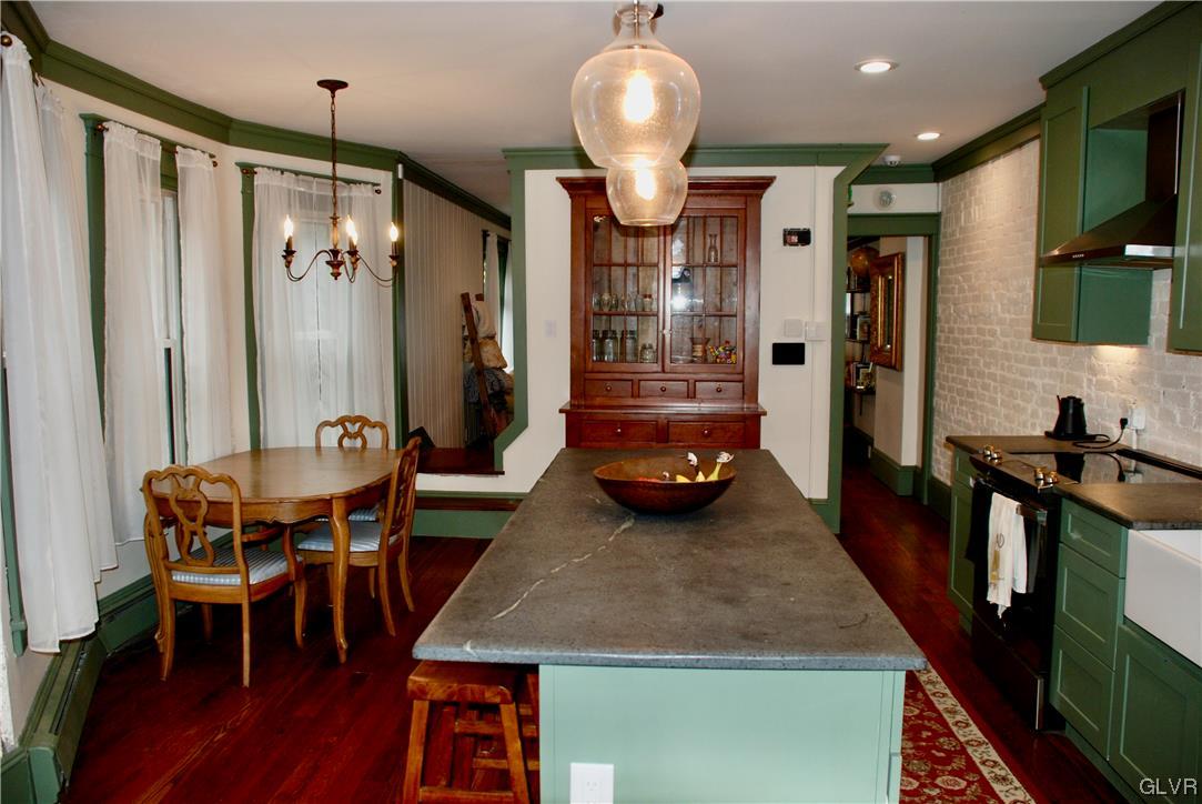 30 North 5th Street Emmaus, PA 18049 - Photo 7 of 20 a dining room with stainless steel appliances granite countertop a table chairs and a refrigerator
