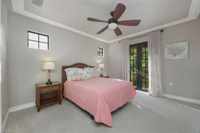 a bedroom with a bed ceiling fan and a window