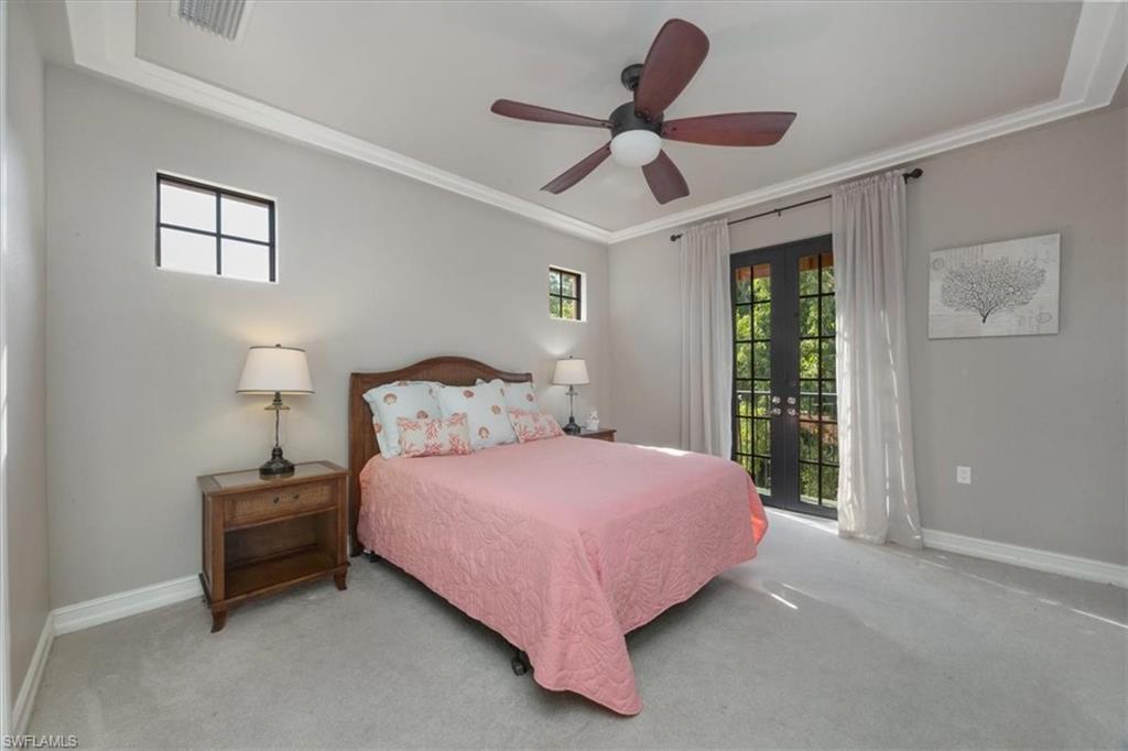 9111 Chula Vista Street, Unit 11604 Naples, FL 34113 - Photo 15 of 33 a bedroom with a bed ceiling fan and a window