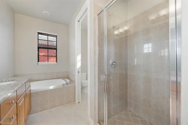 a bathroom with a bathtub a shower a sink and a window