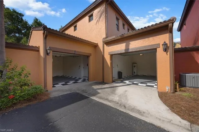 a view of a house with backyard and parking