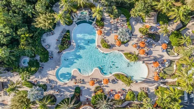 a view of a swimming pool with an outdoor seating and a yard