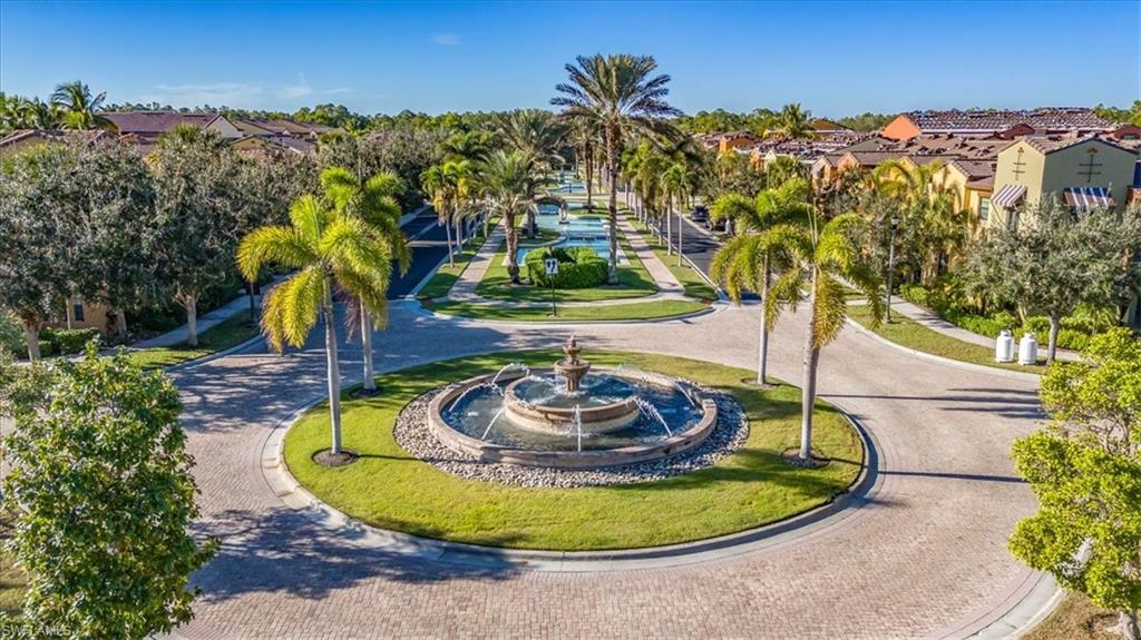 9111 Chula Vista Street, Unit 11604 Naples, FL 34113 - Photo 29 of 33 a view of a swimming pool with an outdoor seating and a yard