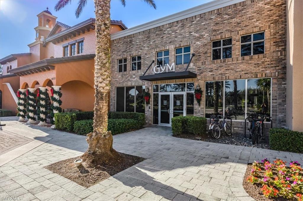 9111 Chula Vista Street, Unit 11604 Naples, FL 34113 - Photo 31 of 33 a front view of a house with garden