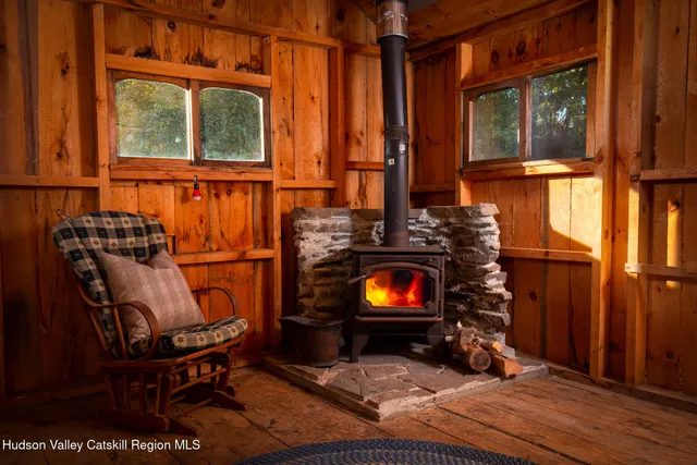 a view of a living room with furniture and a fireplace