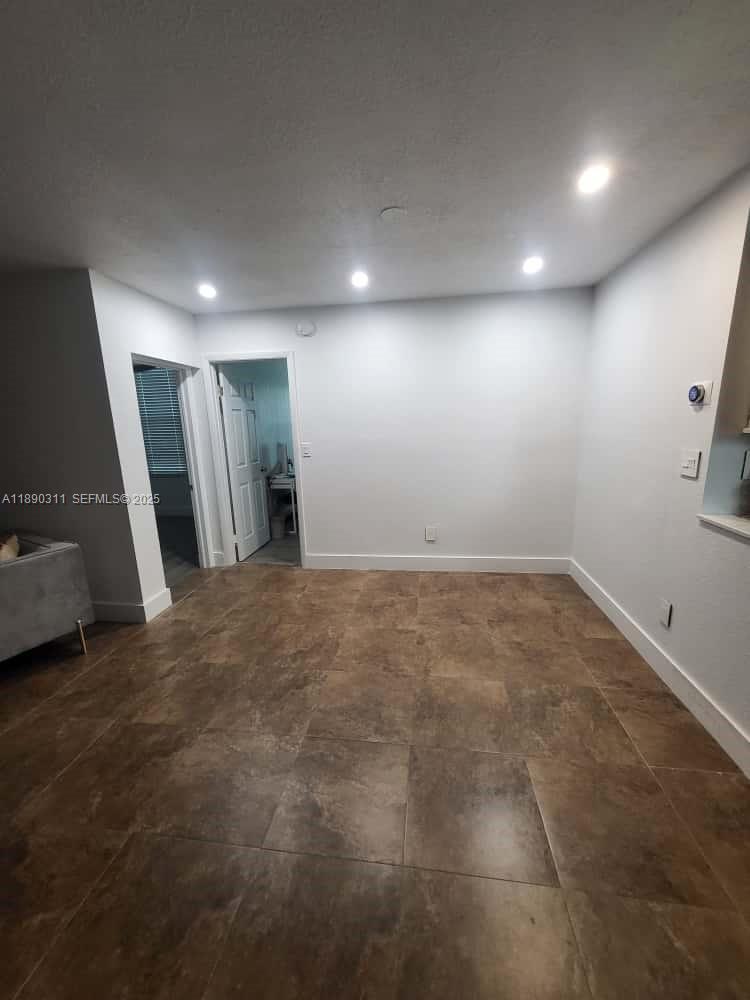 an empty room with a mirror