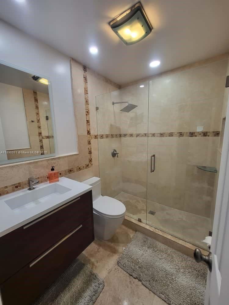 1236 North Hiatus Road, Unit 1236 Pembroke Pines, FL 33026 - Photo 11 of 19 a bathroom with a sink toilet and shower