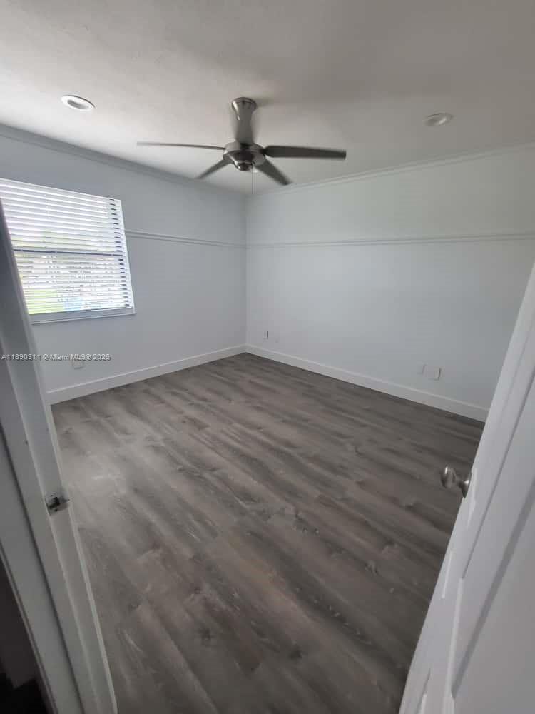 1236 North Hiatus Road, Unit 1236 Pembroke Pines, FL 33026 - Photo 12 of 19 en empty room with wooden floor fan and windows
