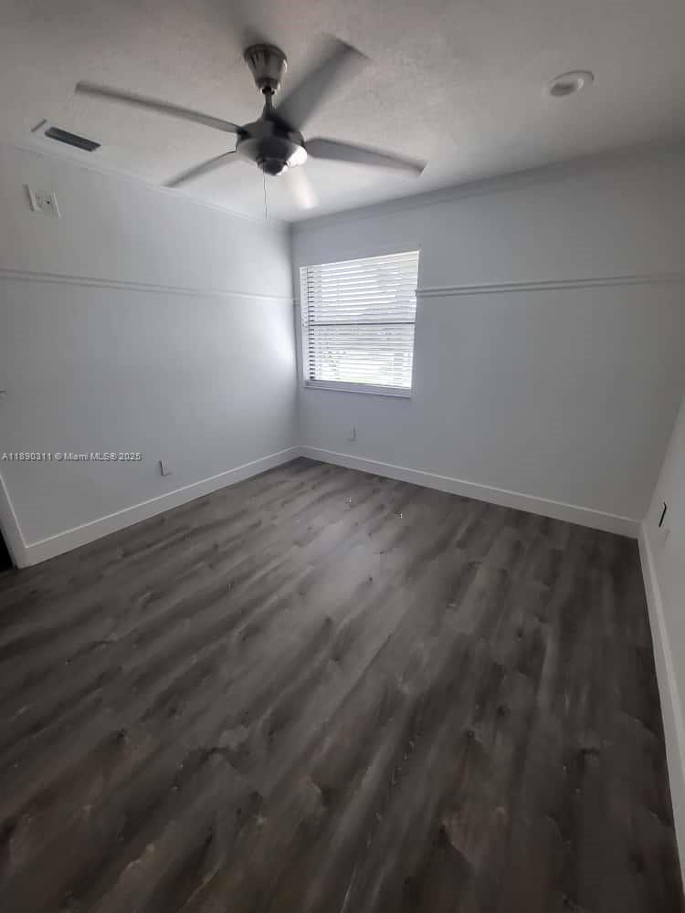 1236 North Hiatus Road, Unit 1236 Pembroke Pines, FL 33026 - Photo 13 of 19 an empty room with a window and a ceiling fan
