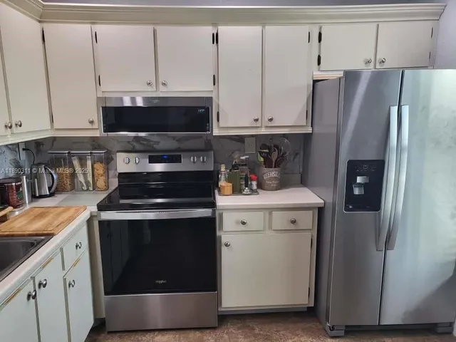 a kitchen with a stove and a refrigerator