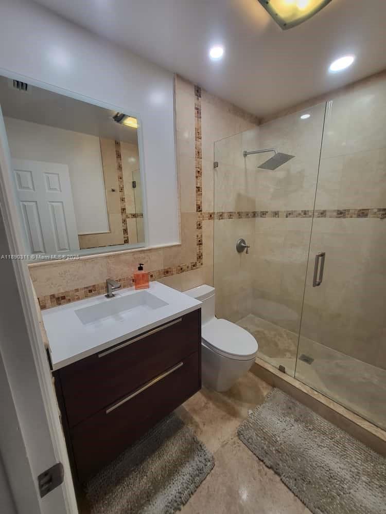 1236 North Hiatus Road, Unit 1236 Pembroke Pines, FL 33026 - Photo 7 of 19 a bathroom with a granite countertop sink toilet and shower