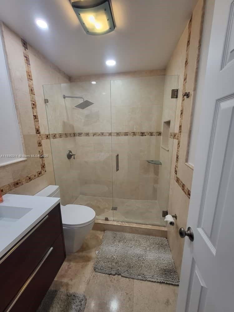 1236 North Hiatus Road, Unit 1236 Pembroke Pines, FL 33026 - Photo 8 of 19 a bathroom with a sink toilet and shower