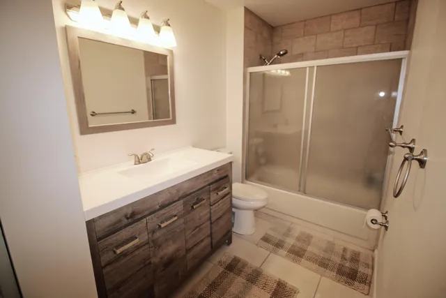 a bathroom with a sink toilet and shower