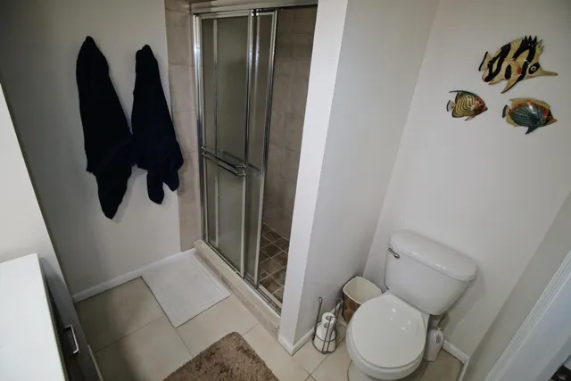 a bathroom with a toilet and a shower
