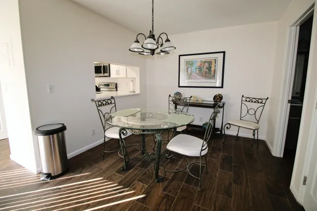 a view of a dining room with furniture wooden floor and a chandelier