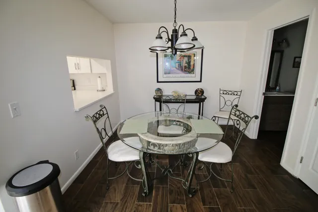 a view of a dining room with furniture a chandelier and wooden floor