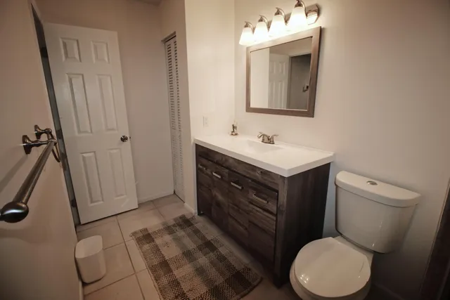 a bathroom with a toilet sink and mirror