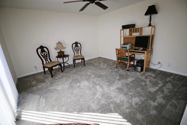 a view of a workspace with furniture