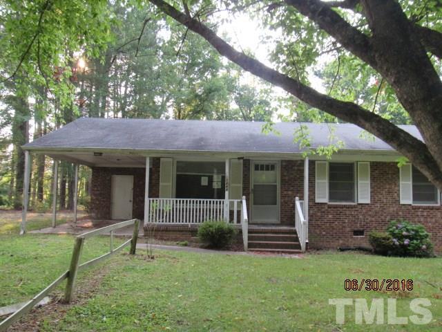 3444 Wiggins Road Spring Hope, NC 27882 - Photo 1 of 14 a view of a house with a yard and a garden