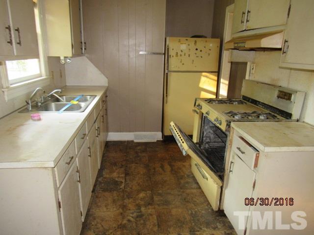3444 Wiggins Road Spring Hope, NC 27882 - Photo 7 of 14 a kitchen with a stove sink and wooden floor