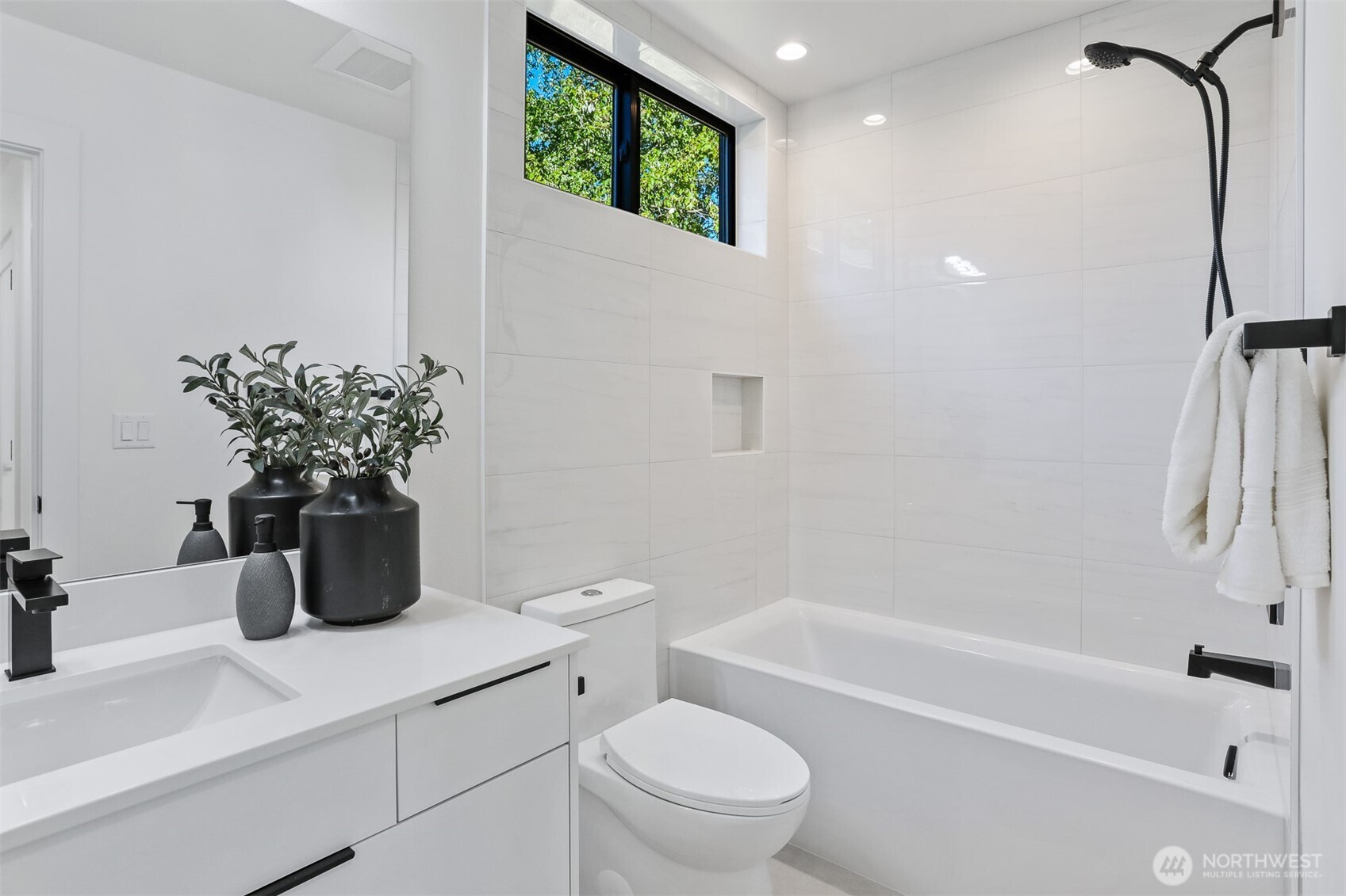 8750 13th Avenue Northwest, Unit B Seattle, WA 98117 - Photo 23 of 28 a bathroom with a sink a toilet and a bathtub