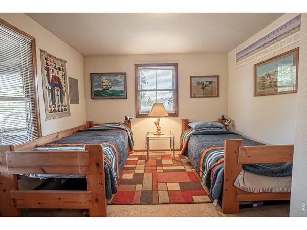 a bedroom with two beds and a window