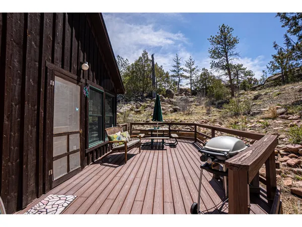 a view of a balcony with chairs and wooden floor