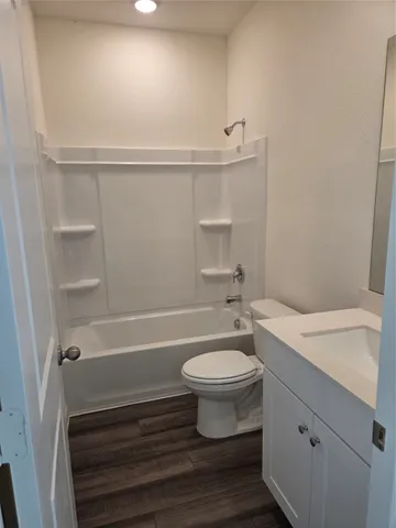 a view of a yard with a small pool and wooden fence