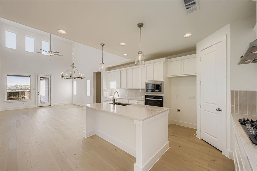 6036 Davis Knoll Road Fort Worth, TX 76126 - Photo 11 of 29 a kitchen with a sink a counter top space stainless steel appliances and cabinets
