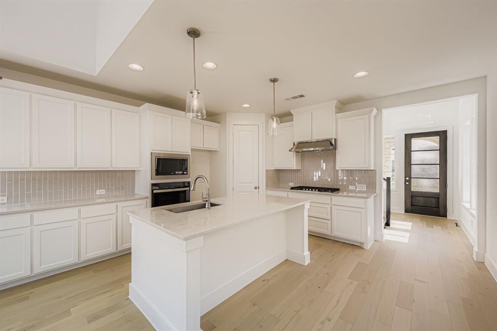 6036 Davis Knoll Road Fort Worth, TX 76126 - Photo 13 of 29 a kitchen with kitchen island a sink stainless steel appliances and cabinets