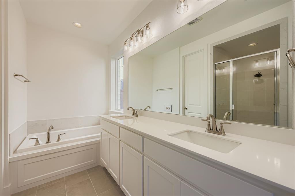 6036 Davis Knoll Road Fort Worth, TX 76126 - Photo 18 of 29 a bathroom with a double vanity sink and mirror with bathtub