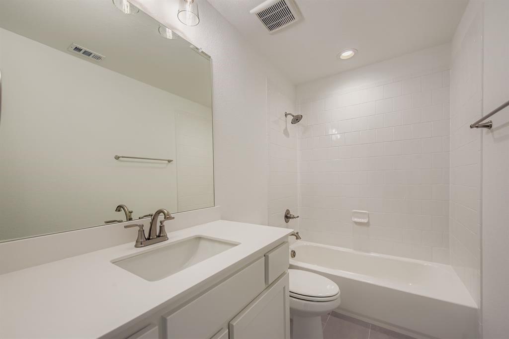 6036 Davis Knoll Road Fort Worth, TX 76126 - Photo 23 of 29 a bathroom with a sink a toilet and a mirror