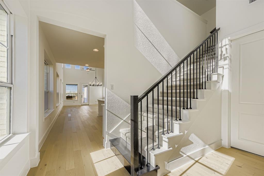 6036 Davis Knoll Road Fort Worth, TX 76126 - Photo 4 of 29 a view of a hallway with wooden floor and staircase