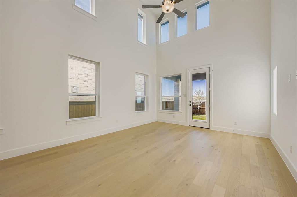 6036 Davis Knoll Road Fort Worth, TX 76126 - Photo 5 of 29 an empty room with windows and pillars in it