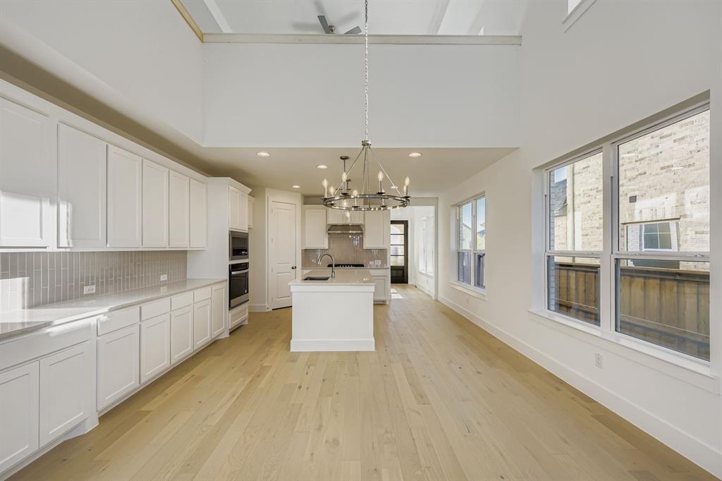 6036 Davis Knoll Road Fort Worth, TX 76126 - Photo 8 of 29 a large white kitchen with a large window appliances and cabinets