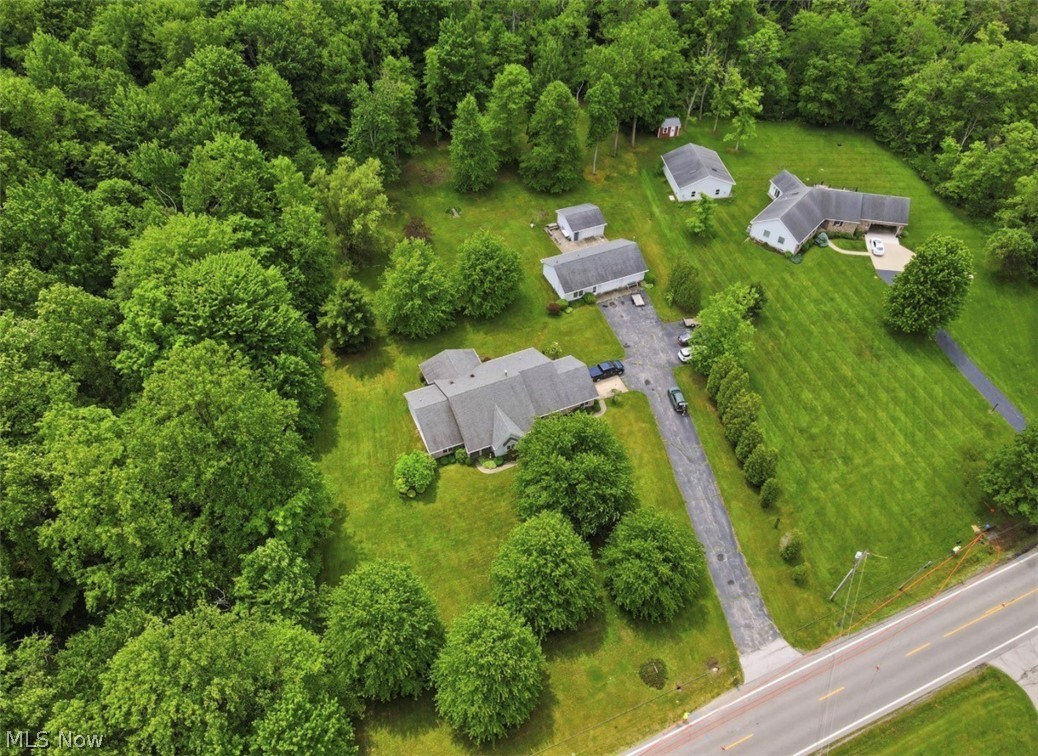 3556 Lake Road Conneaut, OH 44030 - Photo 39 of 39 Expansive property featuring multiple single-story residences with gray roofs, surrounded by extensive green lawns and mature trees