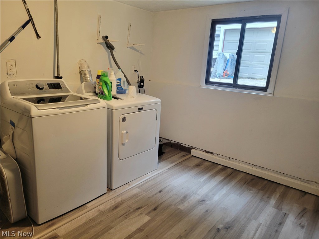 4895 Lear Nagle Road North Ridgeville, OH 44039 - Photo 21 of 27 Laundry area featuring washing machine and dryer and light wood-type flooring
