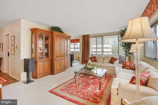 a living room with furniture fireplace and a table