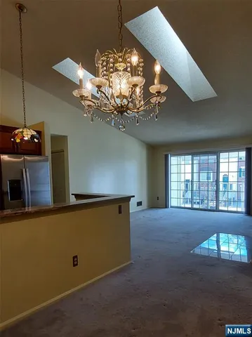 a view of a livingroom with a ceiling fan and window