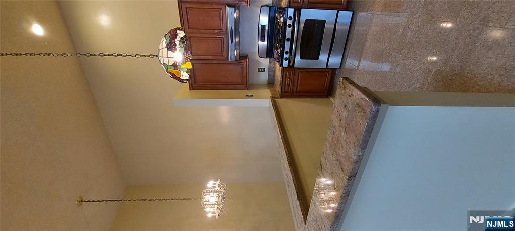 1060 Ash Drive Mahwah, NJ 07430 - Photo 8 of 19 a kitchen with kitchen island a stove a sink and a counter top space